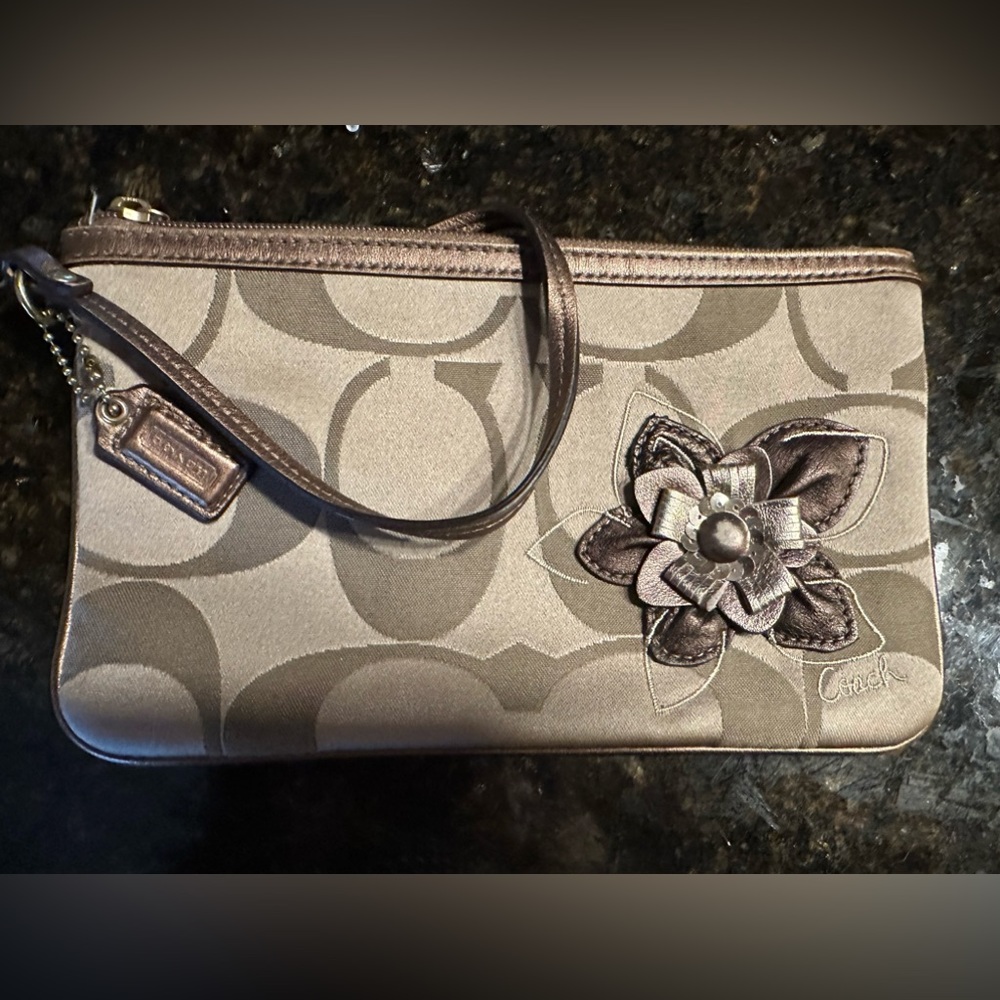 Coach tan wristlet with flower accent.  Timeless. EUC!! Smoke free home.